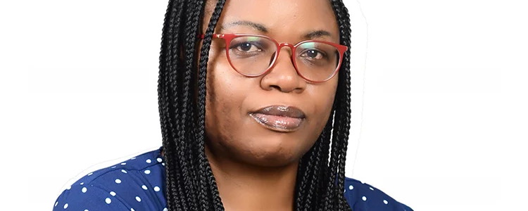 Marie Goretti Uwayezu in a blue top with white dots, in front of a white background.